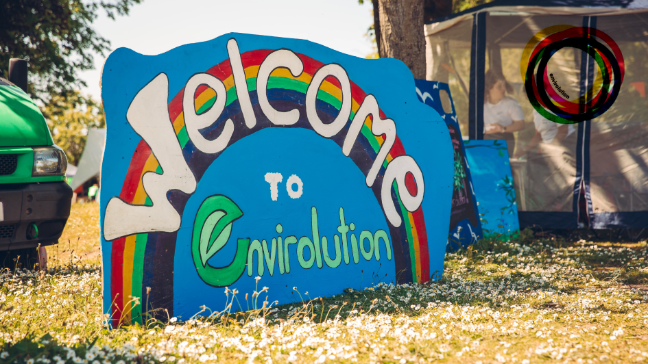 A vibrant scene from the Envirolution Festival showcasing eco-friendly activities and community engagement in a lively atmosphere.