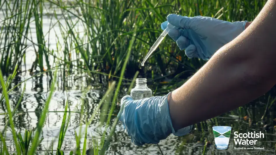 A person testing the water