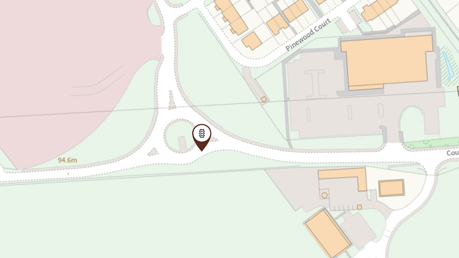 A map showing a roundabout with nearby buildings, parking lots. A location marker is placed at the Slopefield roundabout on Countesswells Road.