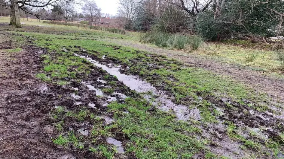 Boggy wet land churned up by machinery tracks and people walking through Culter Bypass.